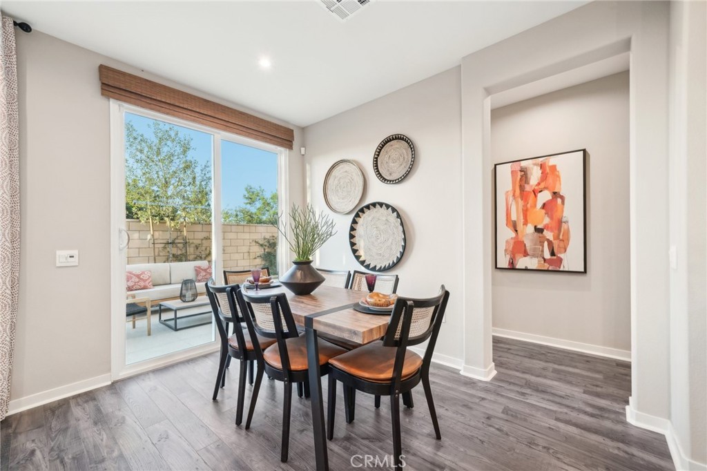16051 Montenegro Lane Fontana, CA 92336 - Photo 2 of 17 a view of a dining room with furniture window and wooden floor