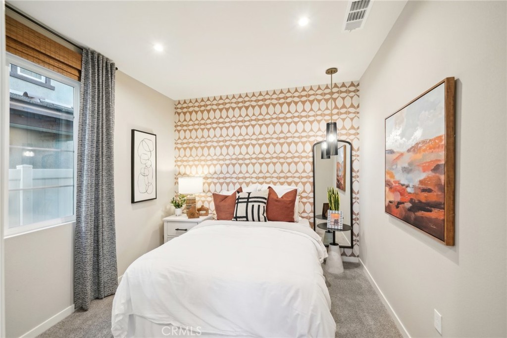 16051 Montenegro Lane Fontana, CA 92336 - Photo 6 of 17 a bed room with a bed and a painting on the wall