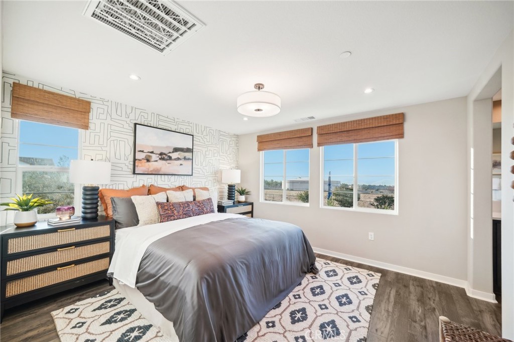 16051 Montenegro Lane Fontana, CA 92336 - Photo 9 of 17 a bedroom with a large bed and a window