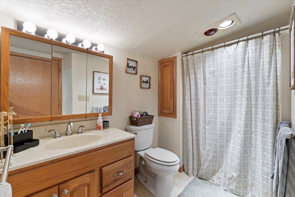 5460 Moline Road Erie, IL 61250 - Photo 13 of 38 a bathroom with a double vanity sink toilet and shower
