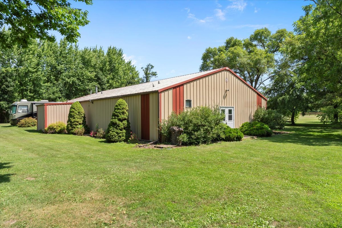 5460 Moline Road Erie, IL 61250 - Photo 17 of 38 a view of a backyard with potted plants and large trees