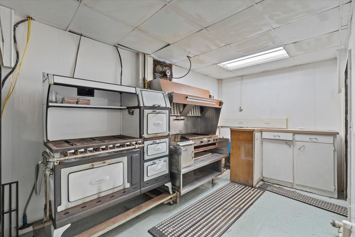 5460 Moline Road Erie, IL 61250 - Photo 24 of 38 a kitchen with white cabinets and appliances