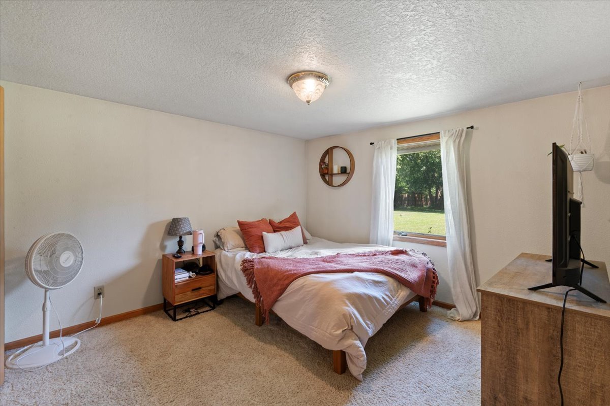 5460 Moline Road Erie, IL 61250 - Photo 8 of 38 a bed room with a bed tv and a window