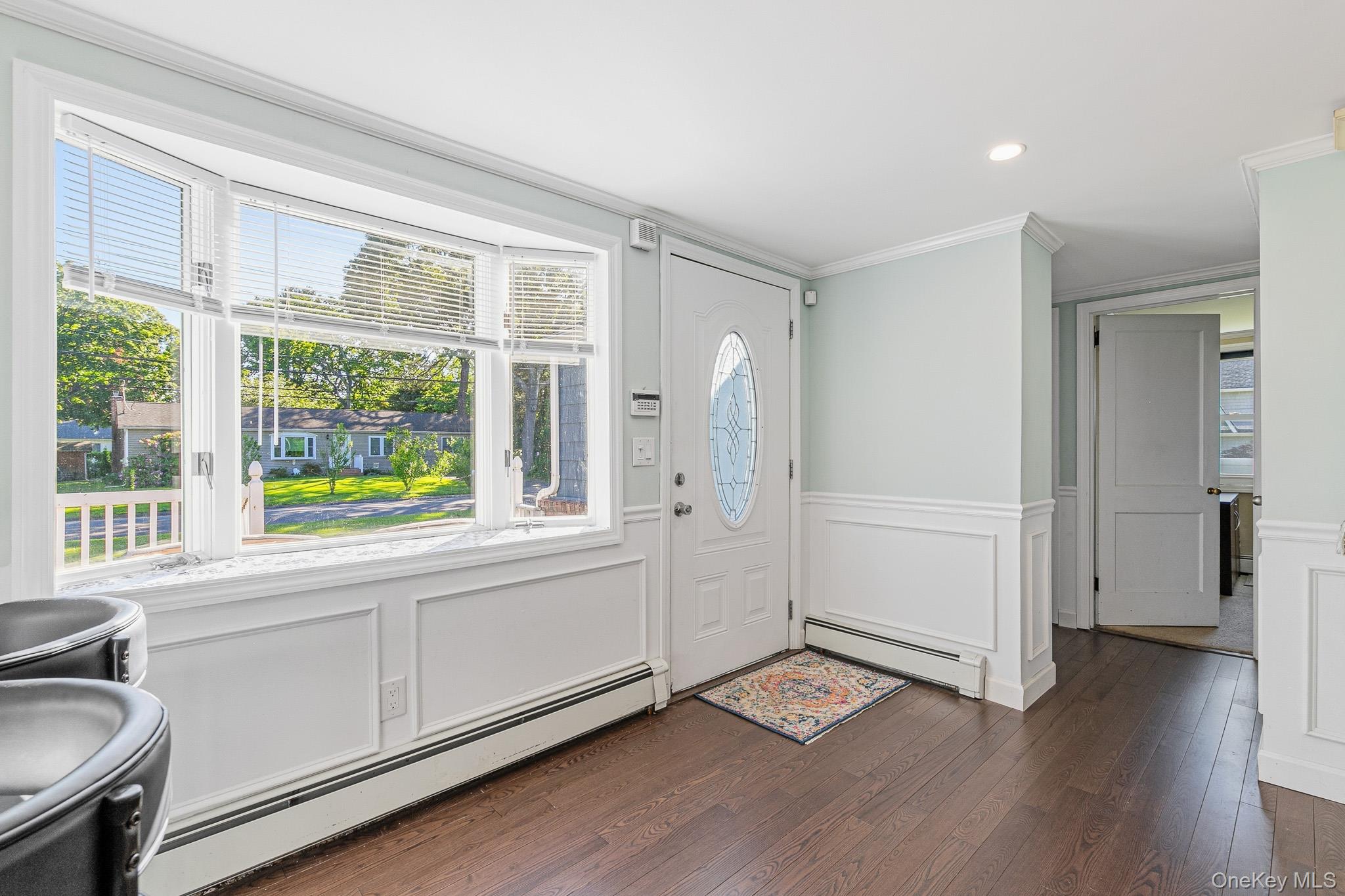 33 Lillian Road Nesconset, NY 11767 - Photo 5 of 42 The Front Porch Leads Into The Welcoming Entrance Foyer Offering A Very Large Open Space For Greeting & Gathering. The Entrance Foyer Offers Beautiful Box Paneled/Wainscoted Walls, Custom Moldings, A Bay Window For Natural Light, And The Entrance Foyer/Gathering Space Opens Into The Kitchen & Into The Formal Living Room.