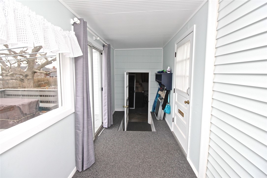 139 Coggeshall Avenue Newport, RI 02840 - Photo 40 of 50 Covered porch area view to back door off driveway, sliders to deck and garage from the back door to kitchen