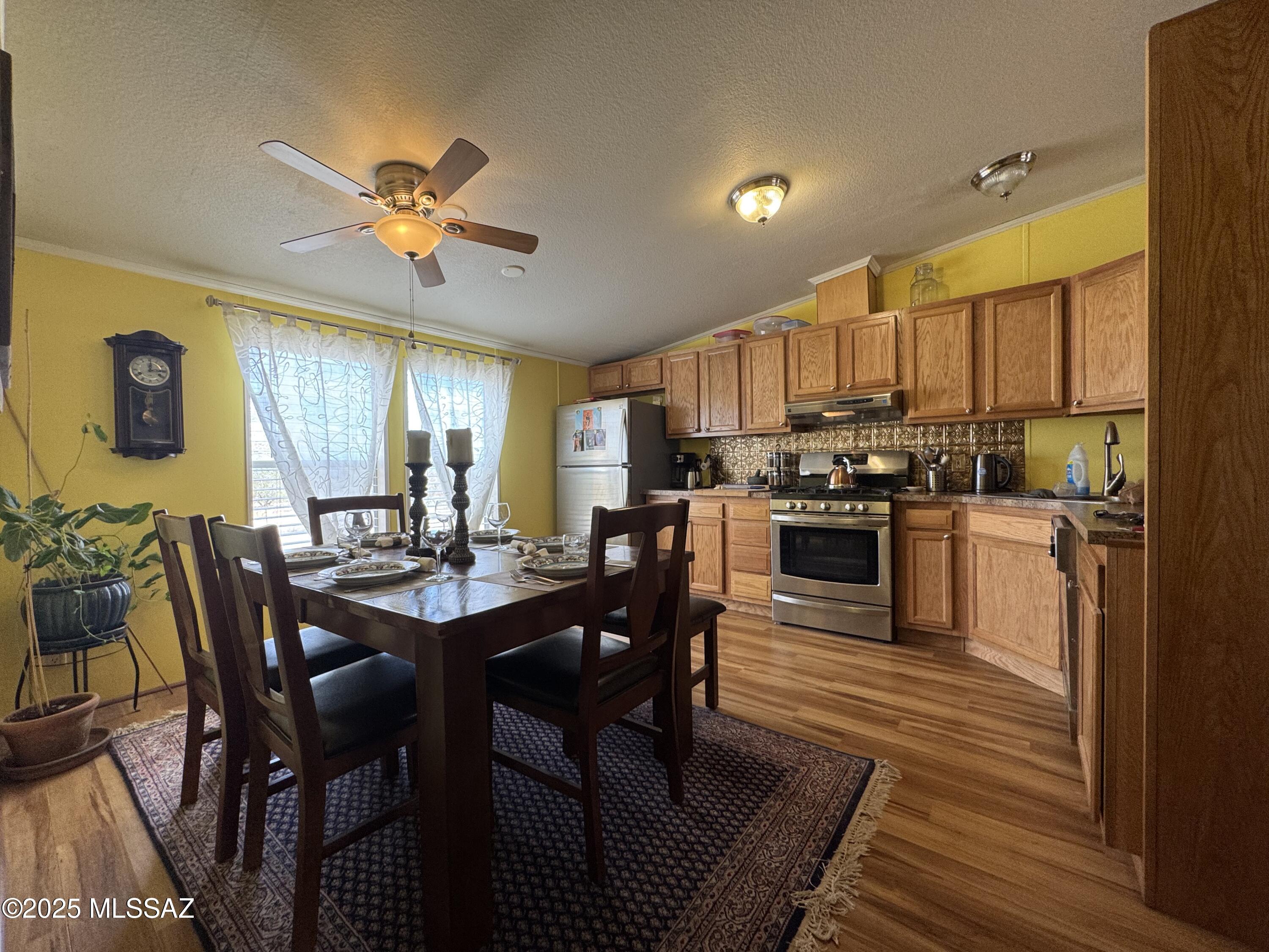 12440 South Coleman Road Tucson, AZ 85735 - Photo 14 of 45 a view of a dining room with furniture and wooden floor