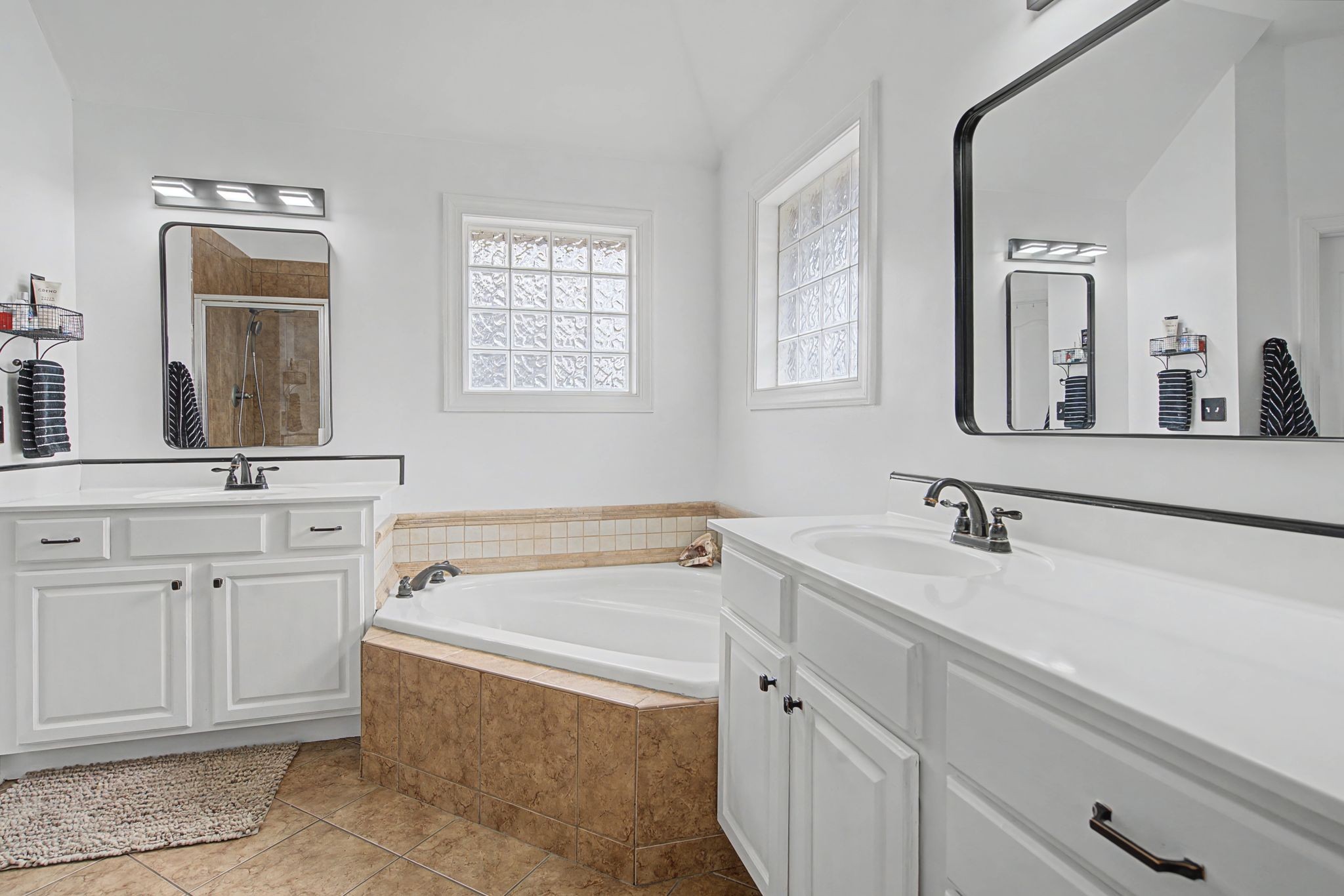 7331 McCormick Drive Fairview, TN 37062 - Photo 18 of 46 a bathroom with a tub sink and mirror