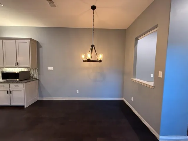 a room with window and a chandelier