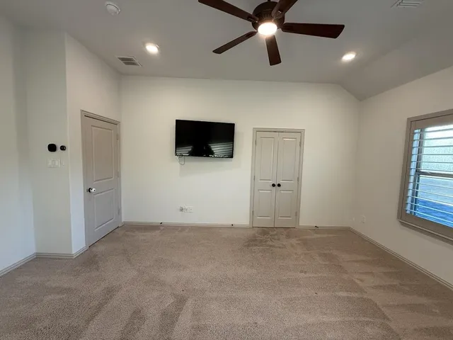 a view of an empty room with a flat screen tv
