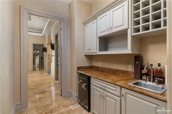 a kitchen with granite countertop a sink and cabinets