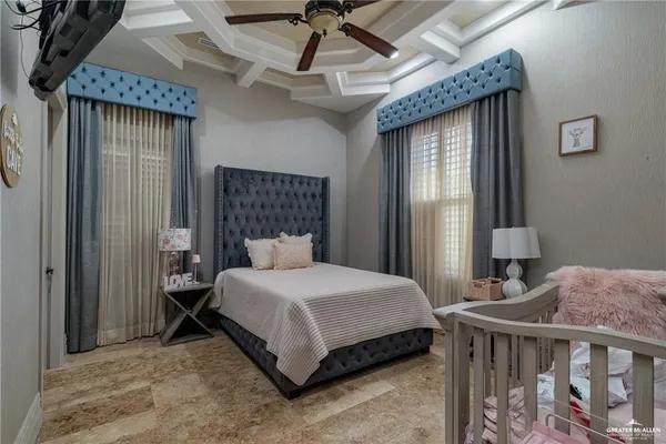 a bedroom with a bed next to a window