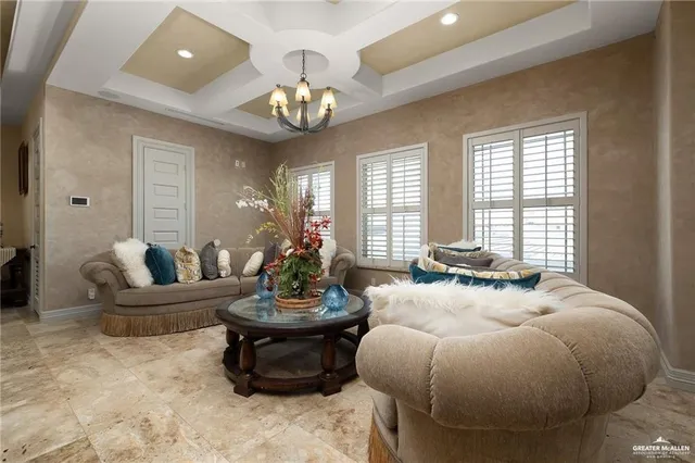 a spacious bedroom with bed and a chandelier