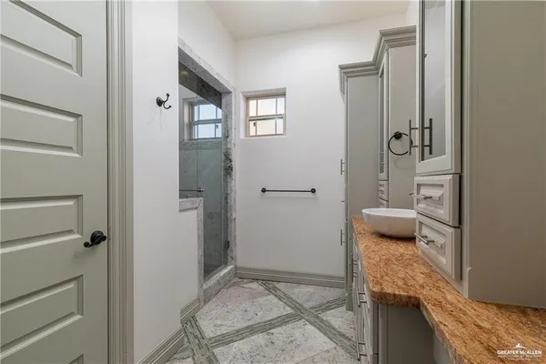 a bathroom with a granite countertop sink and toilet