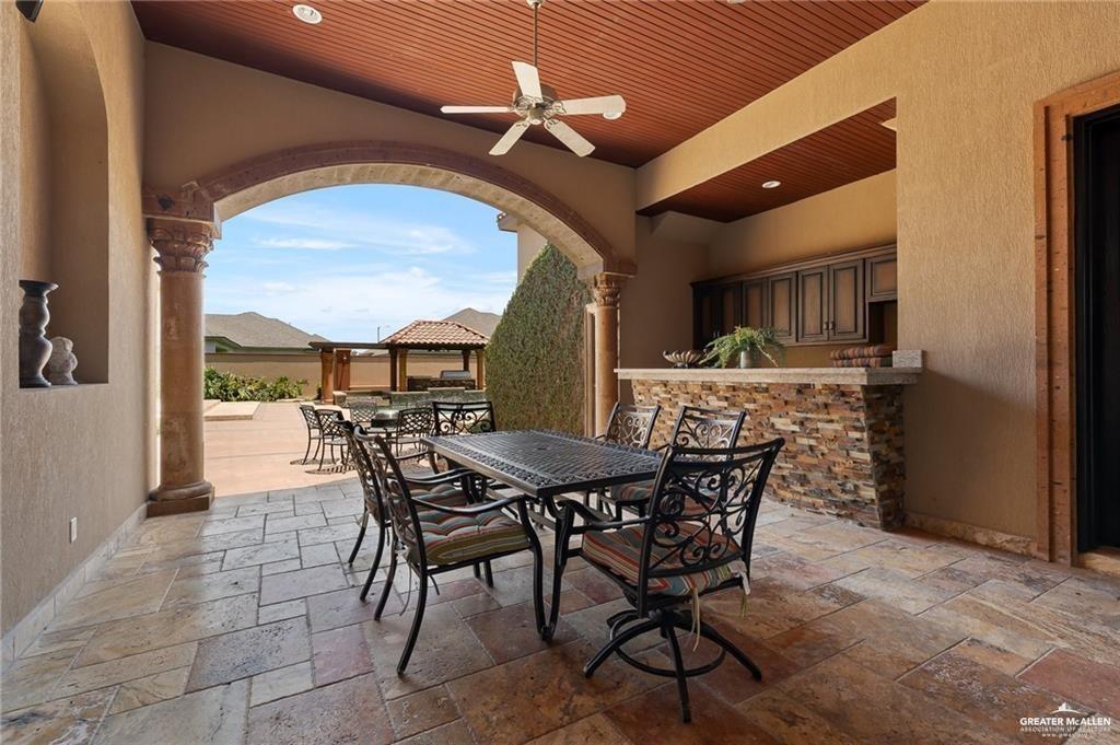 1205 Travis Street Mission, TX 78572 - Photo 35 of 45 a view of a dining room with furniture and a chandelier