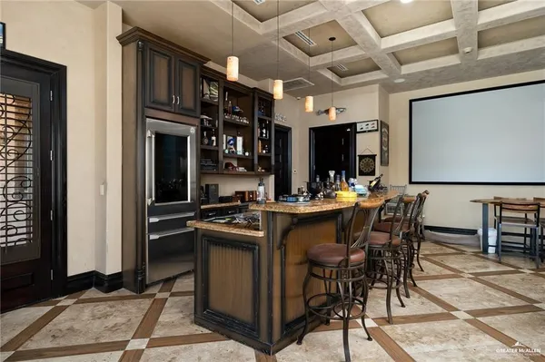 a kitchen with kitchen island granite countertop a sink cabinets and stainless steel appliances