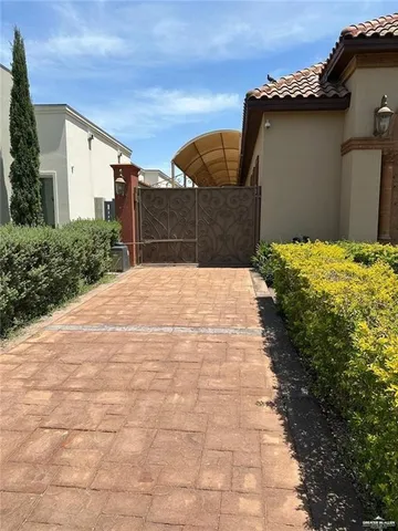 a pathway of a house with a yard