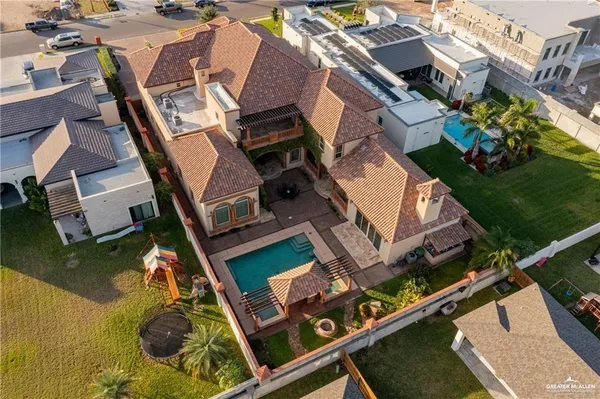 an aerial view of a house with backyard