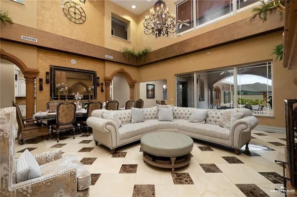 a living room with furniture a rug and a chandelier