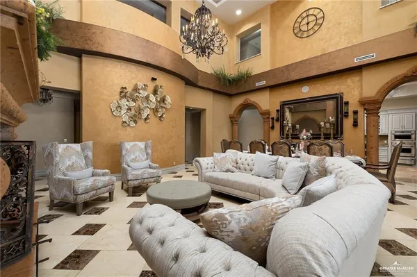 a living room with furniture and a chandelier