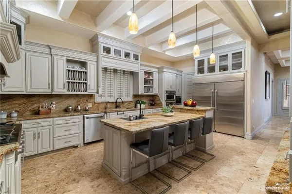a kitchen with a stove sink and cabinets