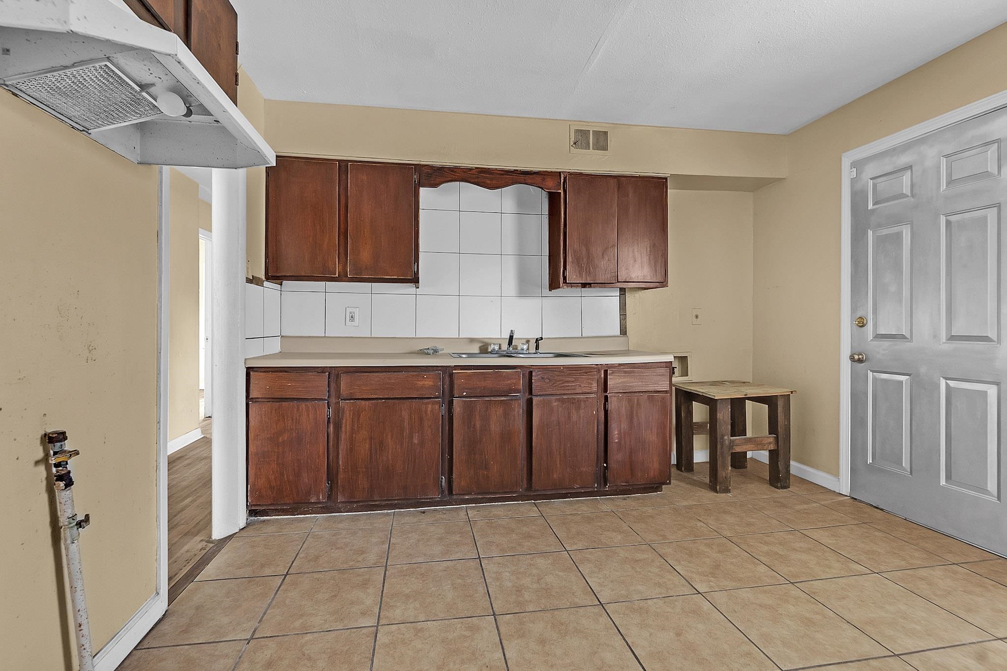 2196 Ketchum Road Memphis, TN 38114 - Photo 13 of 20 a kitchen with a sink a stove and a refrigerator