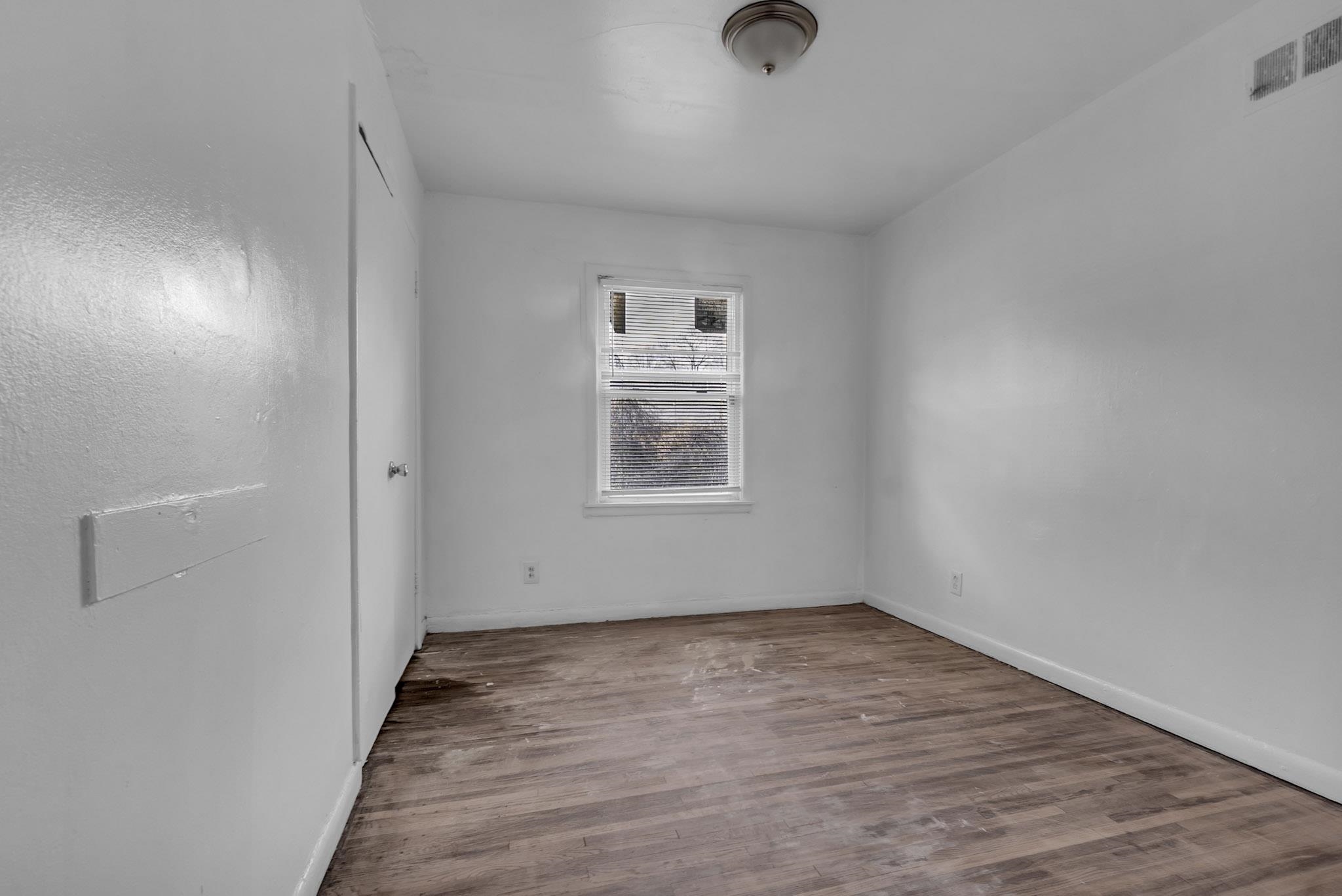 2196 Ketchum Road Memphis, TN 38114 - Photo 14 of 20 wooden floor in an empty room with a window