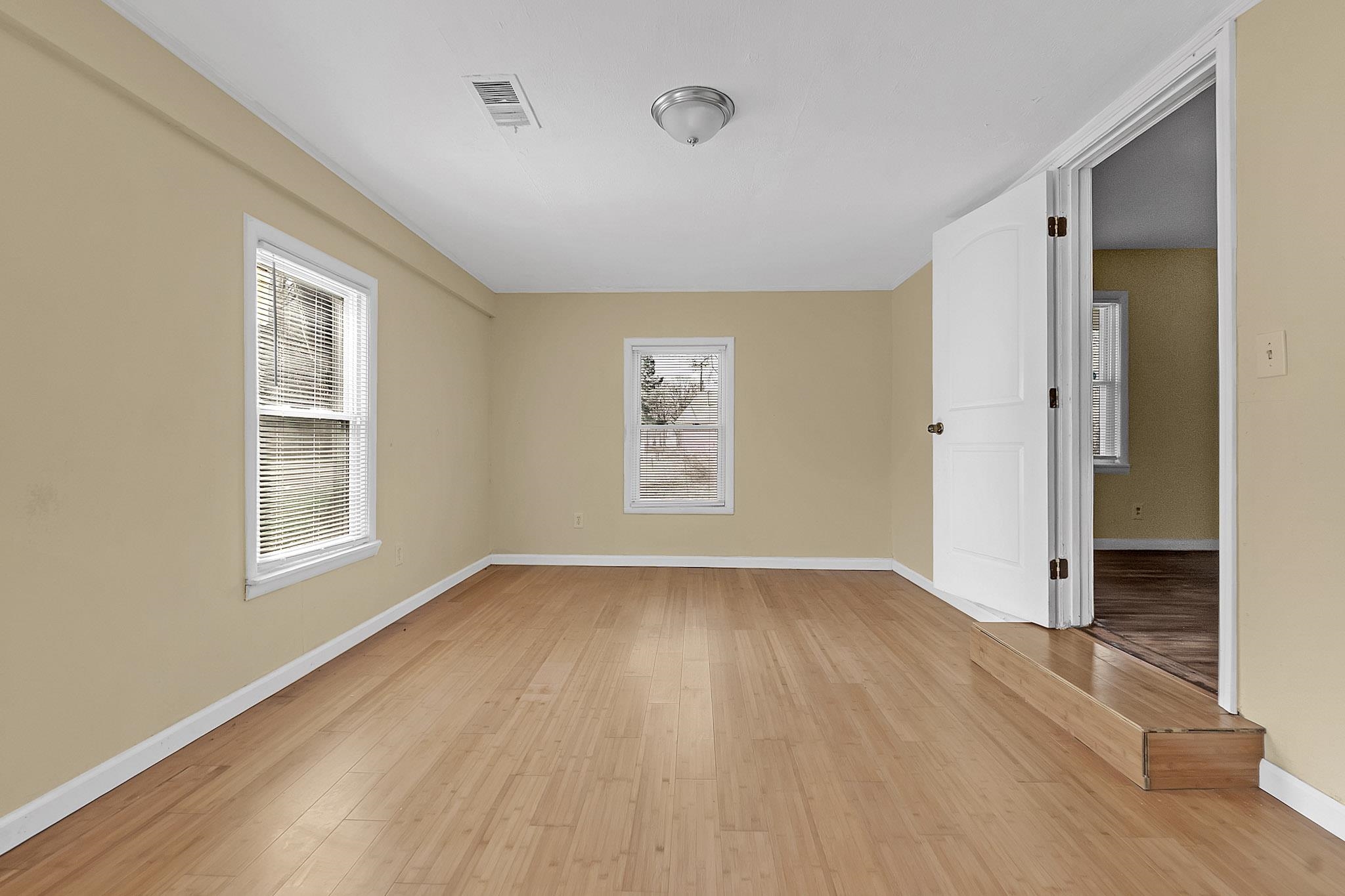 2196 Ketchum Road Memphis, TN 38114 - Photo 17 of 20 an empty room with wooden floor and windows