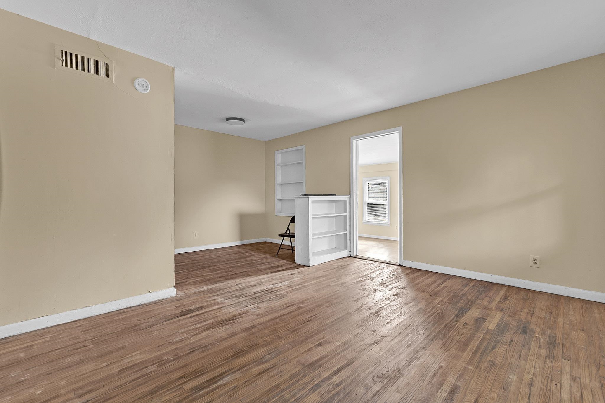2196 Ketchum Road Memphis, TN 38114 - Photo 7 of 20 a view of empty room with wooden floor and window
