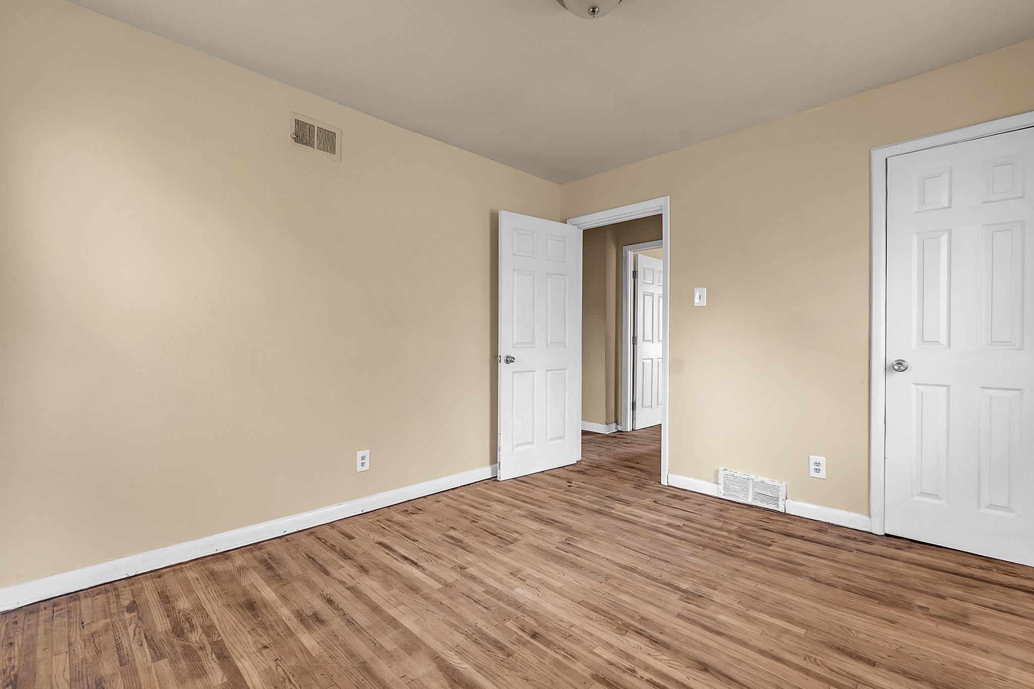2196 Ketchum Road Memphis, TN 38114 - Photo 8 of 20 a view of an empty room with wooden floor and closet