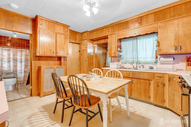 a dining table with chairs and window