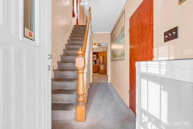 a view of a hallway with wooden floor and entryway