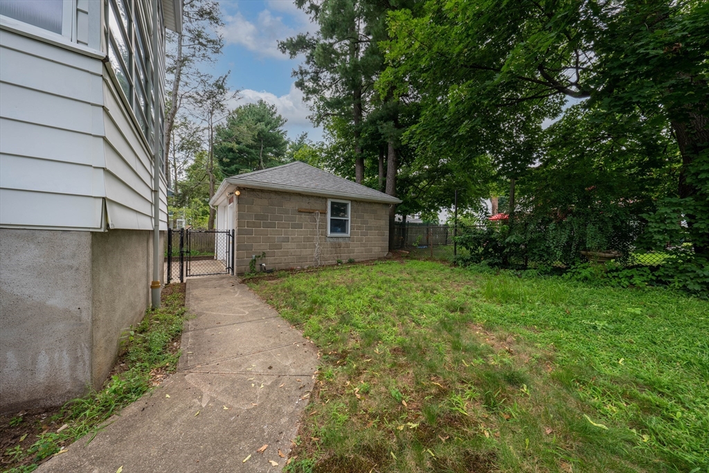 63-65 Evans Street Watertown, MA 02472 - Photo 2 of 18 a front view of a house with garden