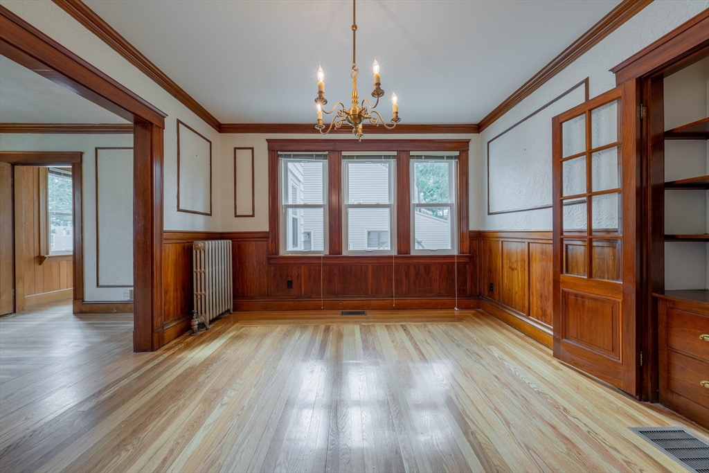 63-65 Evans Street Watertown, MA 02472 - Photo 5 of 18 wooden floor in an empty room with a window