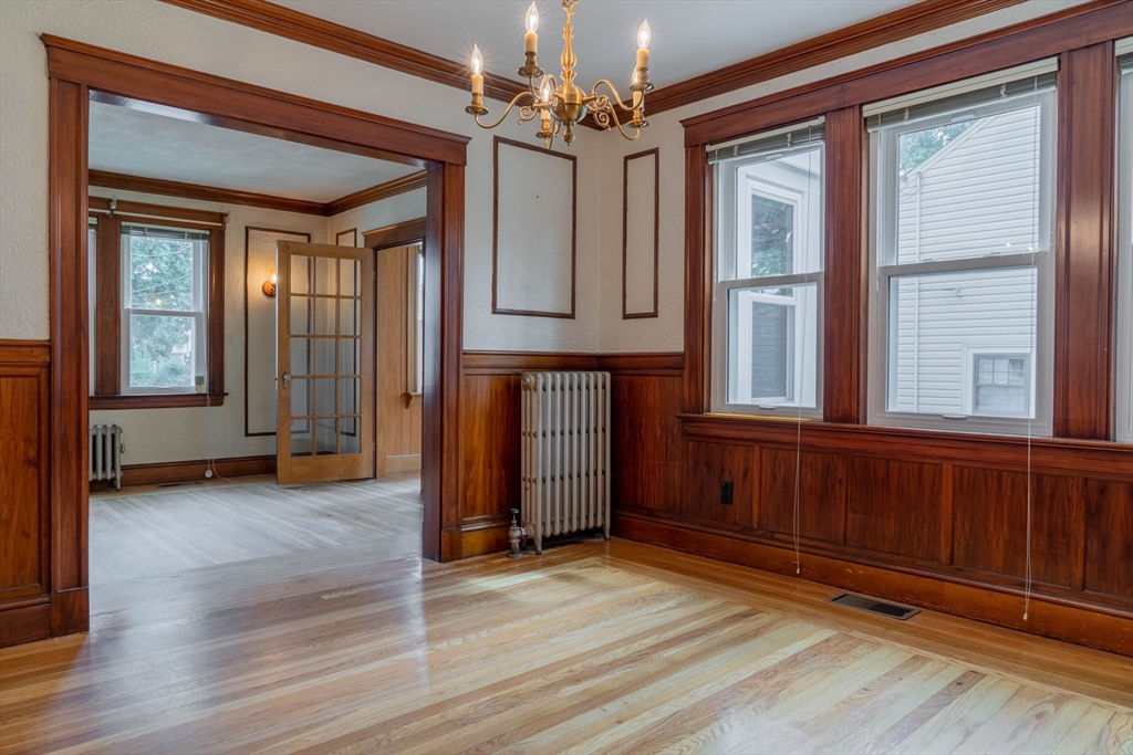 63-65 Evans Street Watertown, MA 02472 - Photo 7 of 18 a view of a room with wooden floor and windows