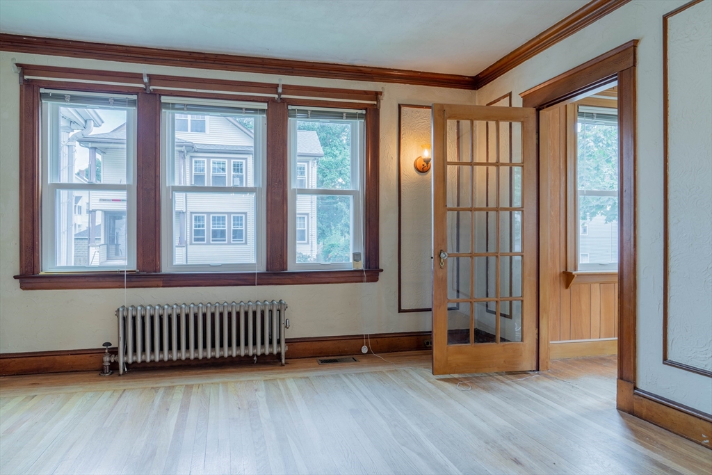 63-65 Evans Street Watertown, MA 02472 - Photo 9 of 18 an empty room with wooden floor and windows
