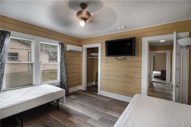 a bedroom with a bed and a flat screen tv