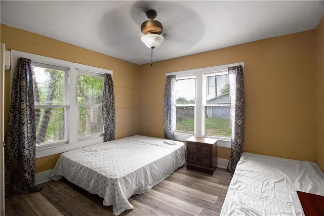 a bedroom with a large bed and a large window