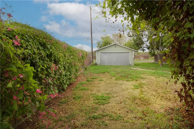 a view of a garden with a house