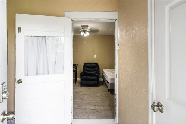 a view of a hallway with closet and bathroom