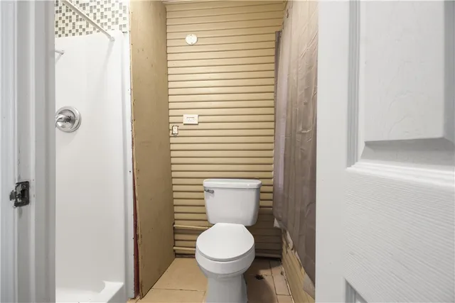 a white toilet sitting next to a bathroom sink
