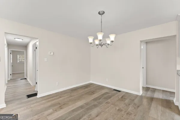 a view of a chandelier in a room with wooden floor