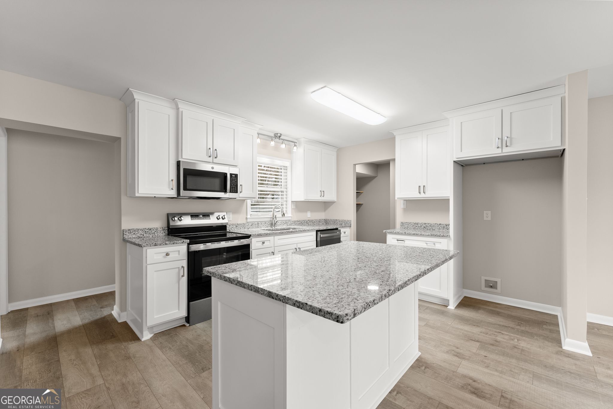 1292 Fernside Drive Toccoa, GA 30577 - Photo 13 of 42 a kitchen with stainless steel appliances granite countertop a sink stove microwave and refrigerator
