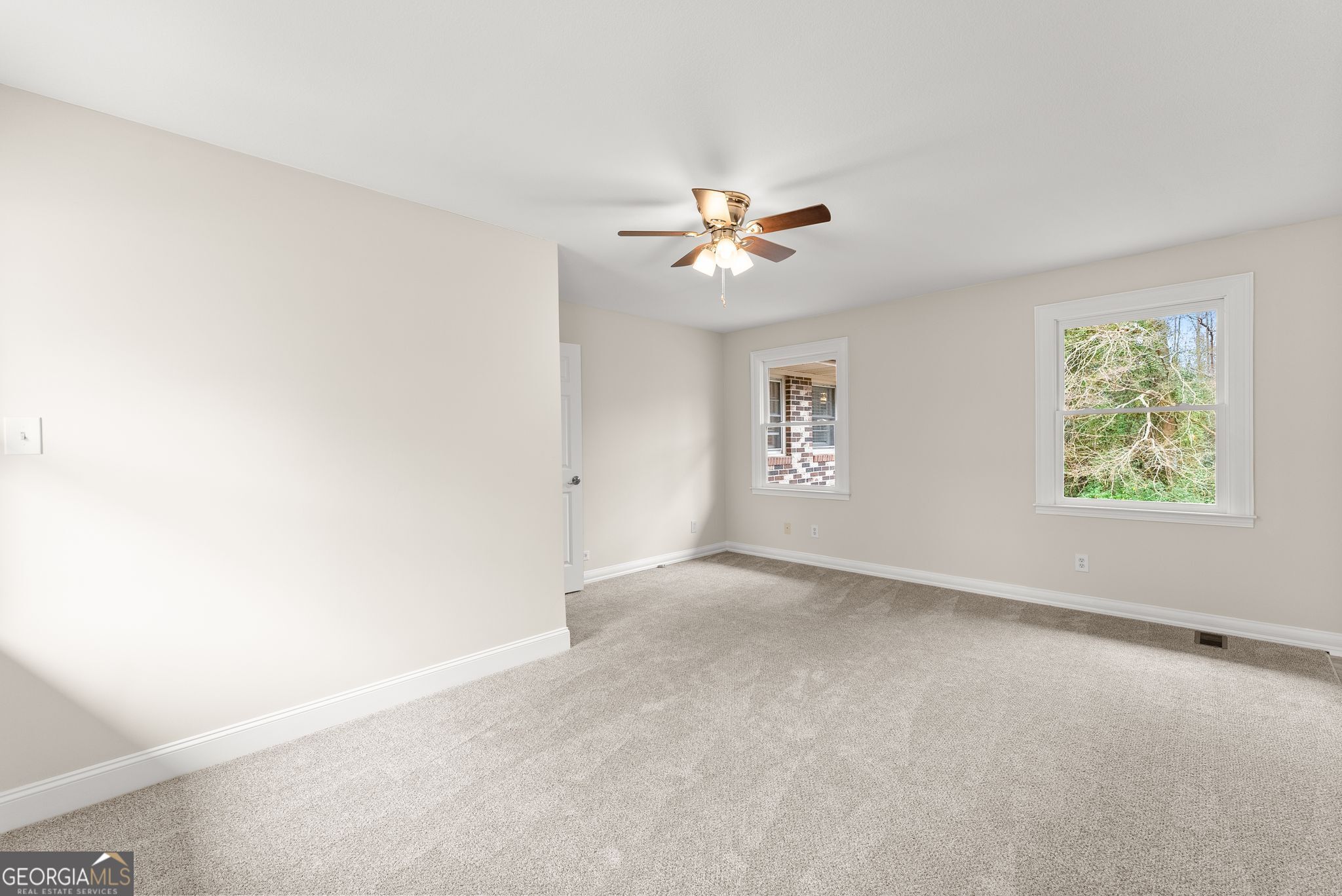 1292 Fernside Drive Toccoa, GA 30577 - Photo 18 of 42 an empty room with windows and chandelier fan