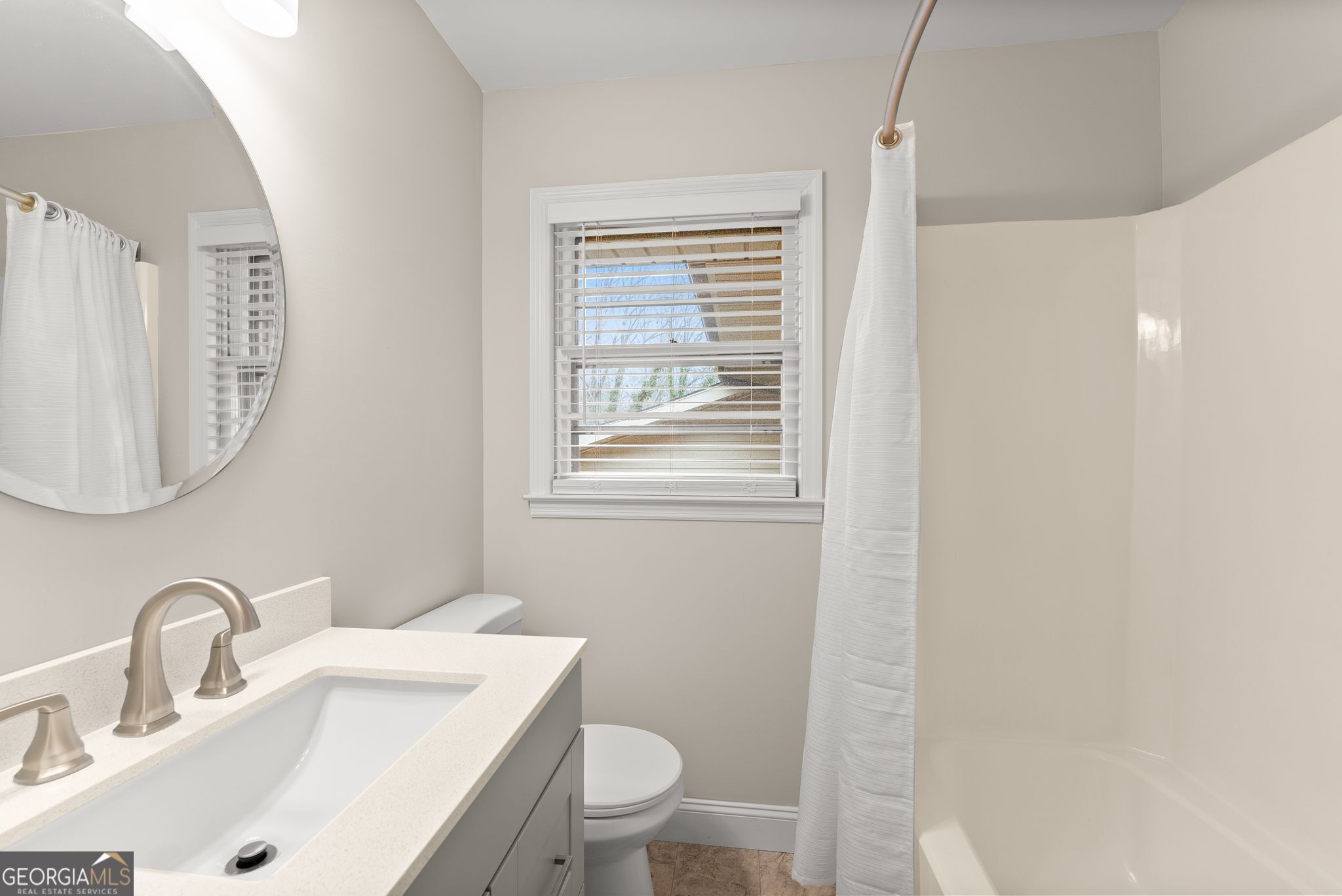 1292 Fernside Drive Toccoa, GA 30577 - Photo 23 of 42 a bathroom with a toilet sink and mirror