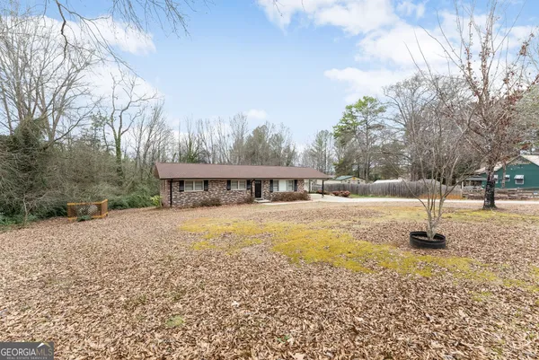 a view of house with outdoor space and sitting area