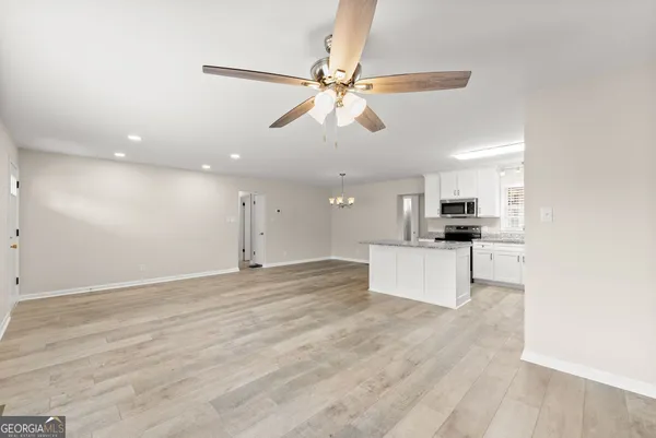 a view of kitchen with refrigerator sink and stove