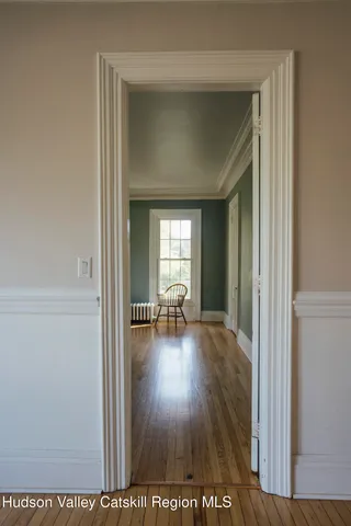 a view of dining room with wooden floor and furniture