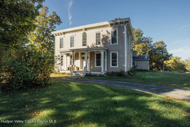 a front view of a house with a garden