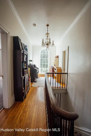 a view of a room with wooden floor and windows