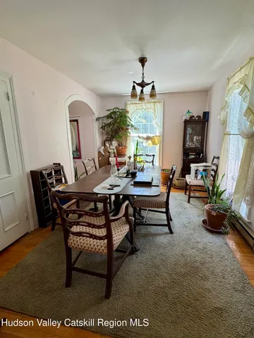 a view of a house with backyard and trees